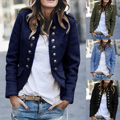 Navy blue double-breasted military style women's blazer with brass buttons, worn with dark jeans, shown in a photograph.